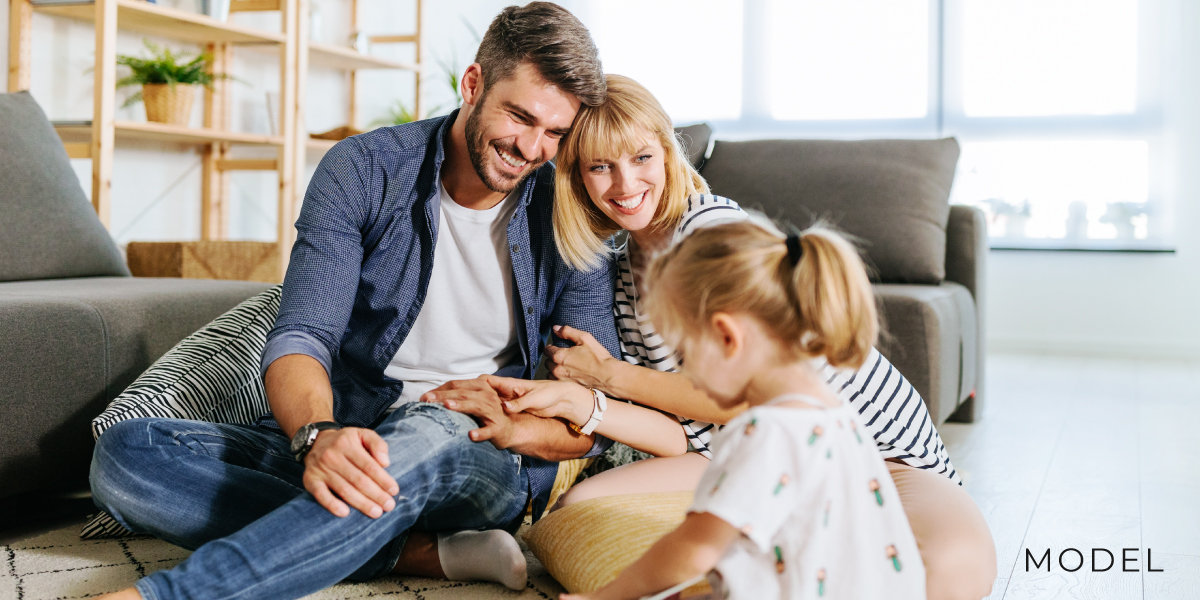 Family of Models Sitting in Living Room