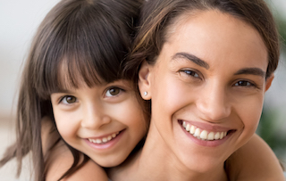 Model of Mother and Daughter Smiling