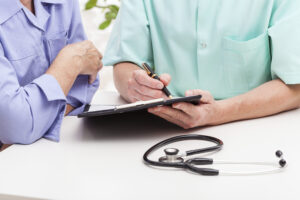 Doctor models fill out paperwork | perri dermatology