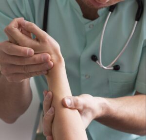 Model of doctor examining a wrist | perri dermatology