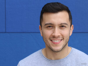 Smiling young male with small facial moles