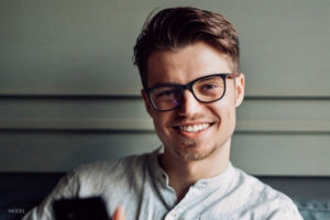 Young male with glasses smiling